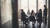 A group of business people meet in a conference room