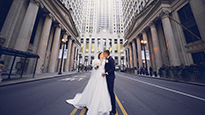 A bride and groom kiss on a Chicago street