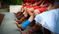 close up of a bride and bride's maids wearing cowboy boots