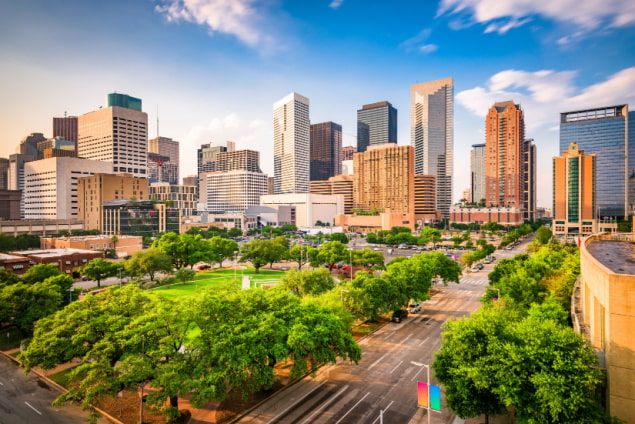 a view of houston's cityscape on a clear evening