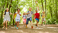 Children run in a forest