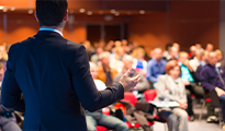 a person in a suit leads a meeting