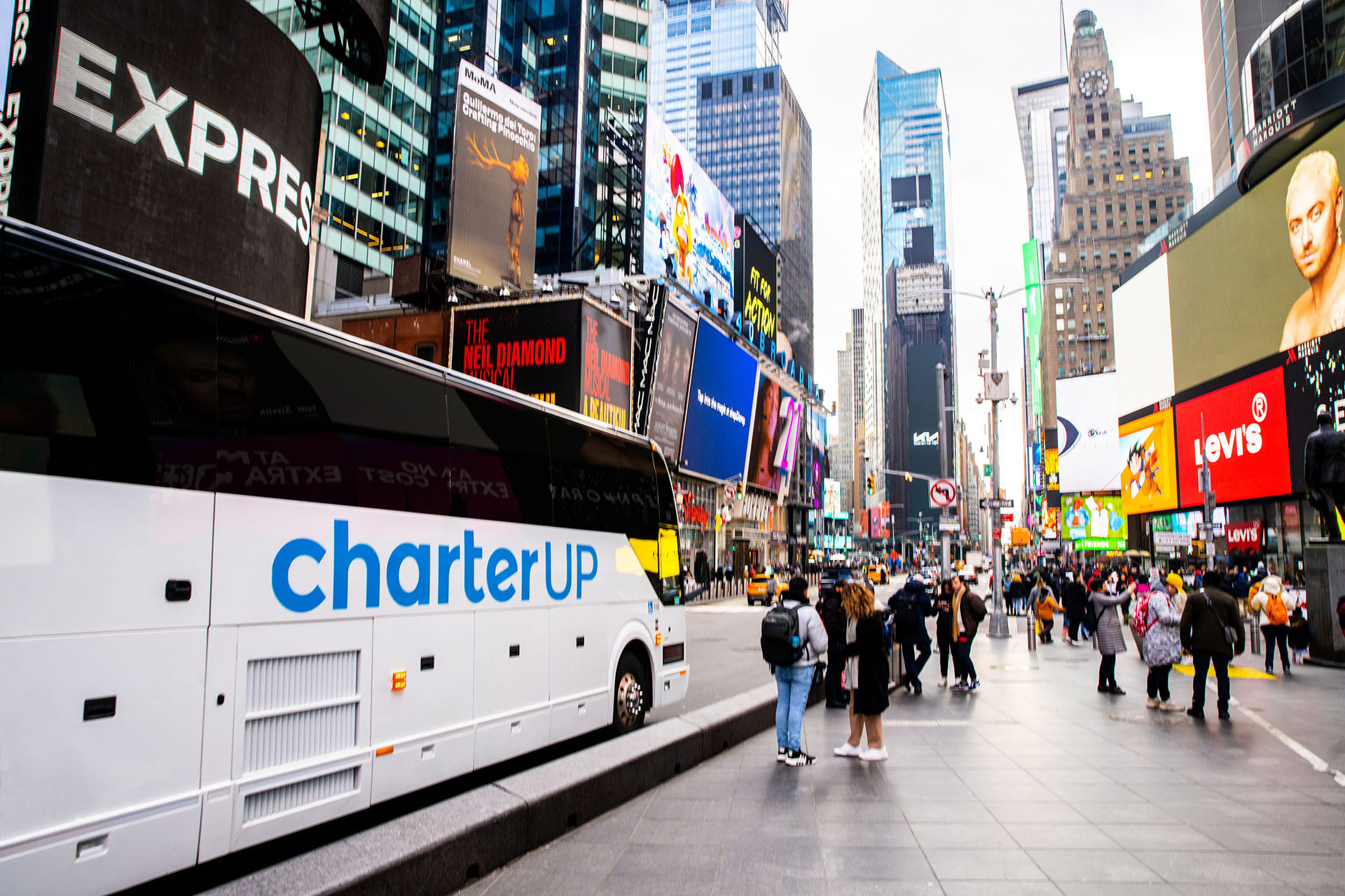 A CharterUP motorcoach travels through Times Square in New York City