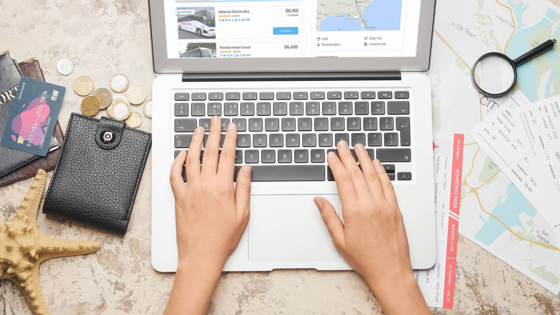 A travel agent searches on a laptop for charter bus rentals