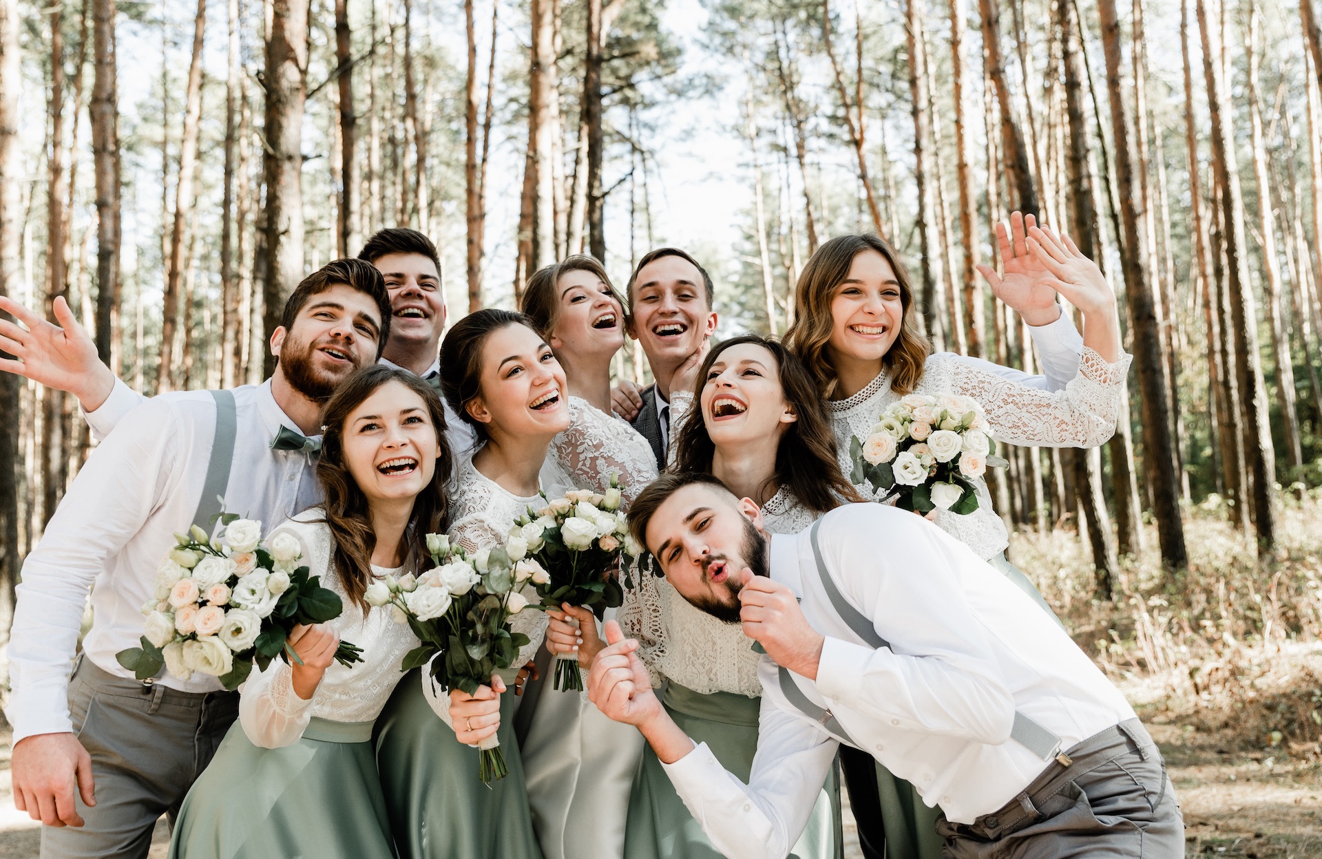 group of young people hugging tightly and laughing cheerfully,a group of friends celebrating a wedding day,lovely friendly family,witnesses and witnesses at the wedding