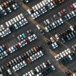 Aerial view of the parked new cars at the automotive plant