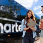 Travelers walk beside a CharterUP bus
