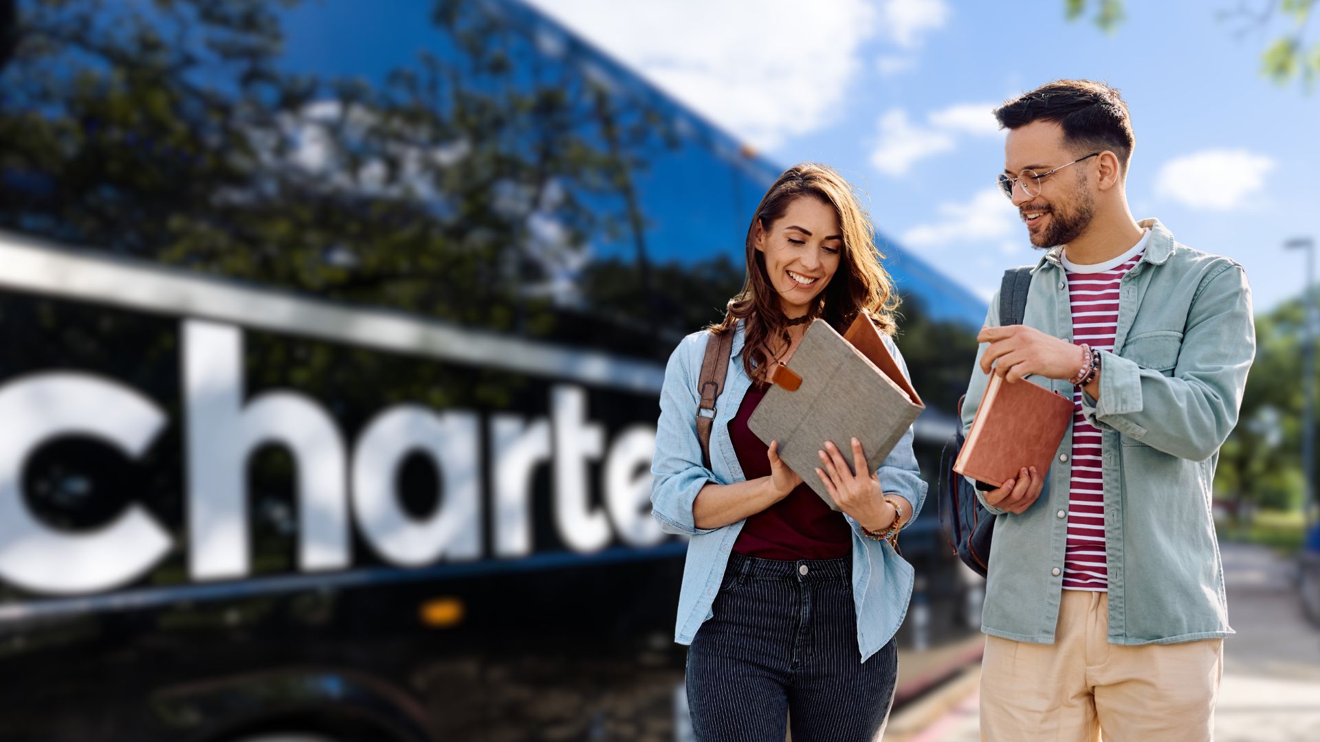 Travelers walk beside a CharterUP bus